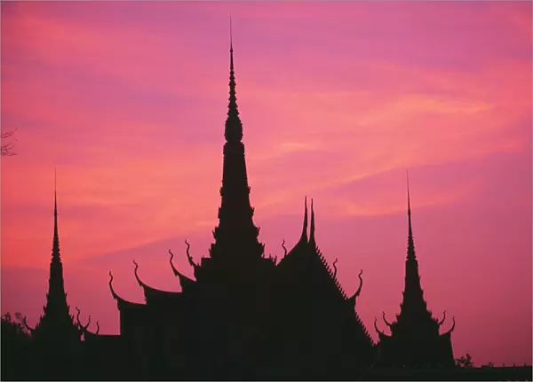 Cambodia, Phnom Phen, Silhouette Of Palace Architecture At Sunset