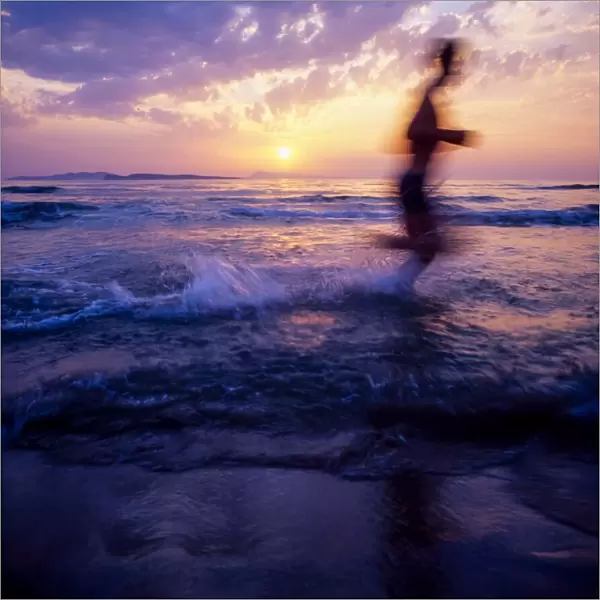 Silhouette Of A Man Running On Beach At Sunset; Ireland
