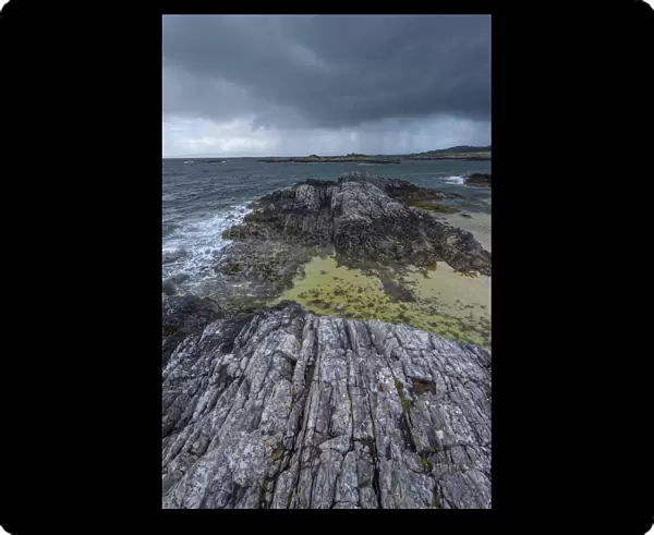 Scottish coast in spring with rain clouds over the ocean at Mallaig in Scotland, United Kingdom