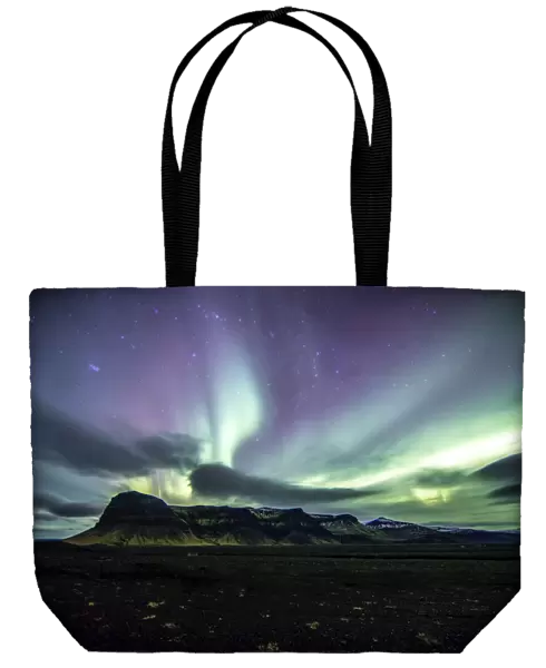 northern lights dance over a mountain range on Icelands South Coast, Vik, Iceland