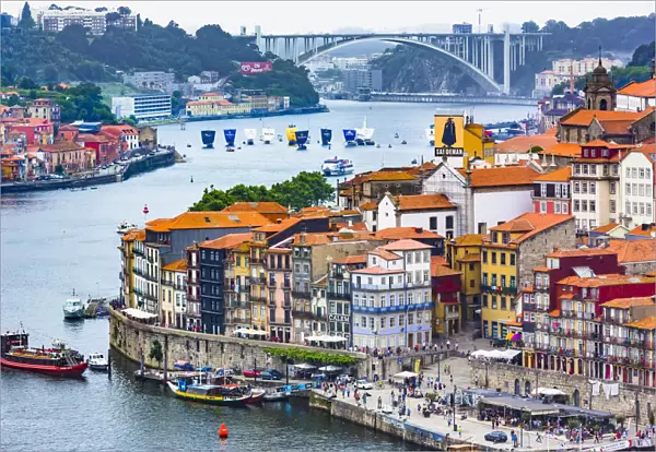 Overview of harbor and waterfront with the Arrabida Bridge in the background in Porto, Norte, Portugal