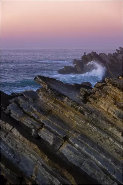 Sunset over rugged rocks at Praia Baleal, Peniche, Oeste, Portugal