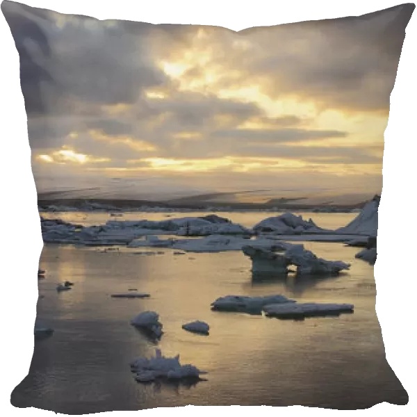 Pieces of ice calves floating in glacial lagoon jokulsarlon at twilight; iceland