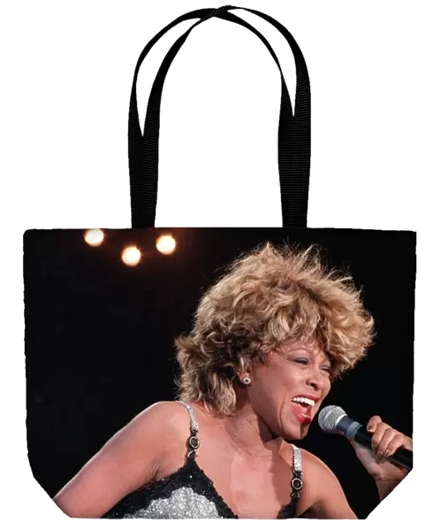 Tina Turner performing live on stage at the SECC Glasgow wearing a silver mini dress
