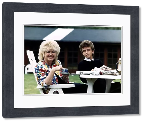Gloria Hunniford TV and Radio Presenter with her son Michael sitting at a table drinking