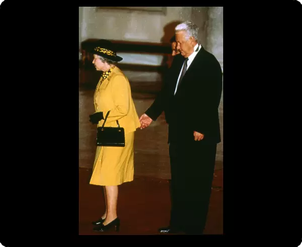 Queen Elizabeth with Boris Yeltsin standing behind and appearing to pinch the monarch