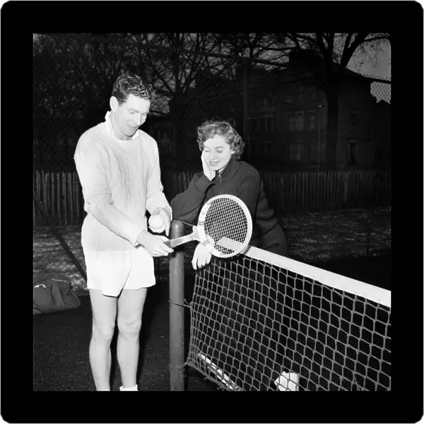 Man and woman talking after enjoying a game of tennis January 1953 D500