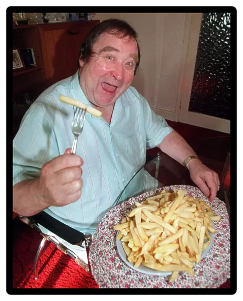 Bernard Manning comedian with plate of McCains Less fat chips