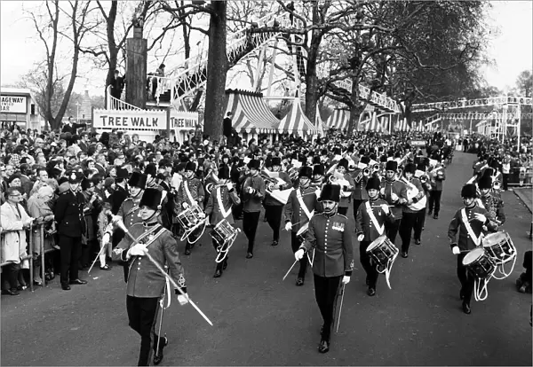 A military band leads the Battersea Easter Parade of 1971 as crowds gather to watch