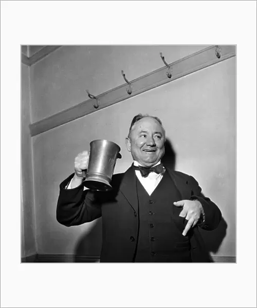 Hector Hughes, Q. C. Labour M. P. for Aberdeen North enjoys a tankard of Inn Coope beer