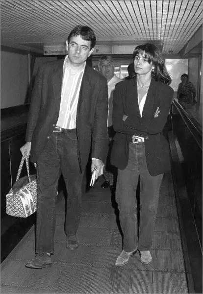 Rowan Atkinson leaving Heathrow Airport with girl. July 1992 P016999