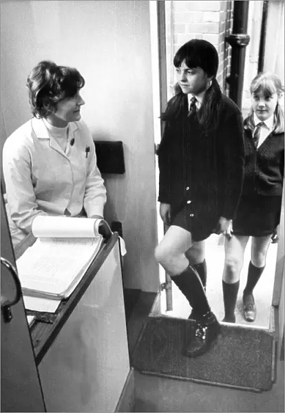 Two young girls visit the school nurse