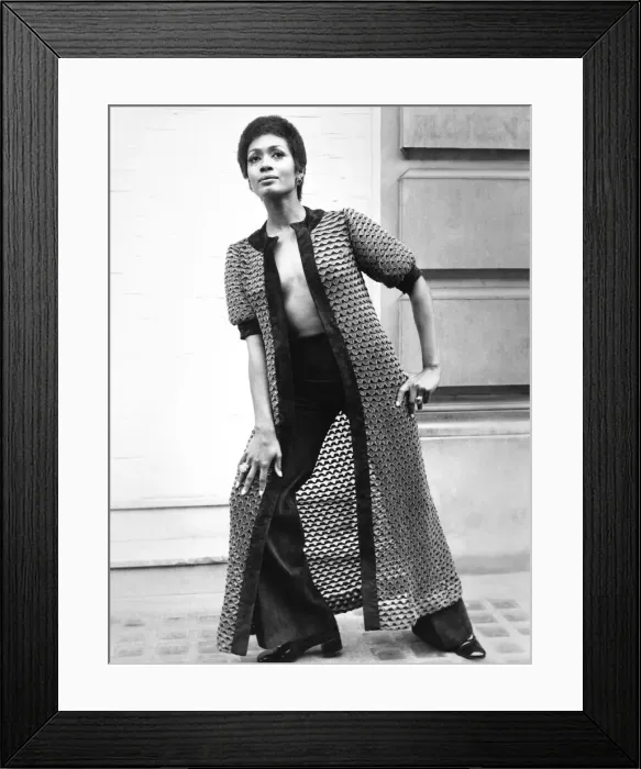 Framed Print : Fashion 1960s Print: A woman models a long coat and matching suede pants Framed Print : Fashion 1960s Print: A woman models a long coat and matching suede pants