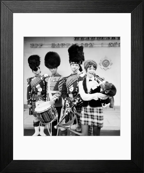 Framed Print : Black and white print of a young woman attempting to play the bagpipes Framed Print : Black and white print of a young woman attempting to play the bagpipes