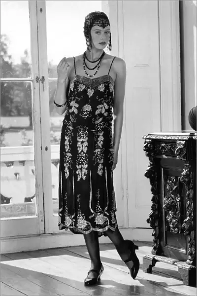 Fashions 1920 s: Beaded flapper dress and skull cap with neat T-bar shoes