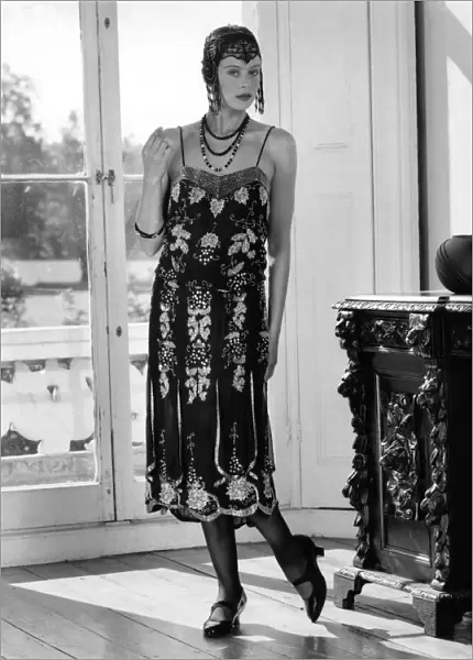 Fashions 1920 s: Beaded flapper dress and skull cap with neat T-bar shoes