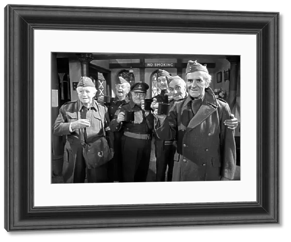 Stars of the popular wartime comedy television programme Dads Army toast each other after