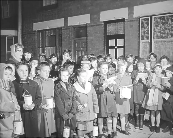 Pupils from Frederick Bird Junior School, Coventry, singing carols in the Hillfields area