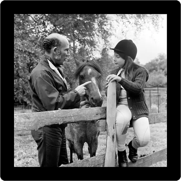 Sterling Moss (Ex Racing Driver). Seen here with horse and daughter. June 1974 S74-3861