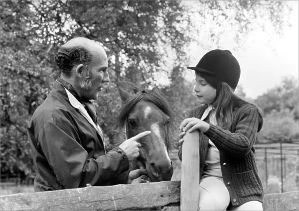 Sterling Moss (Ex Racing Driver). Seen here with horse and daughter. June 1974 S74-3861