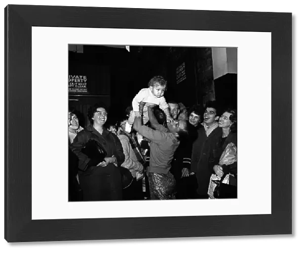 Eartha Kitt with her baby daughter Kitt meeting fans outside the stage door after a dress