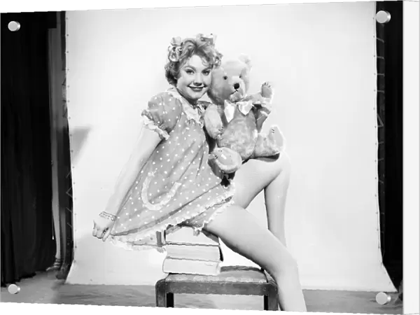 Model Audrey Nicholson wearing nightee seen here with her Teddy bear. 1959