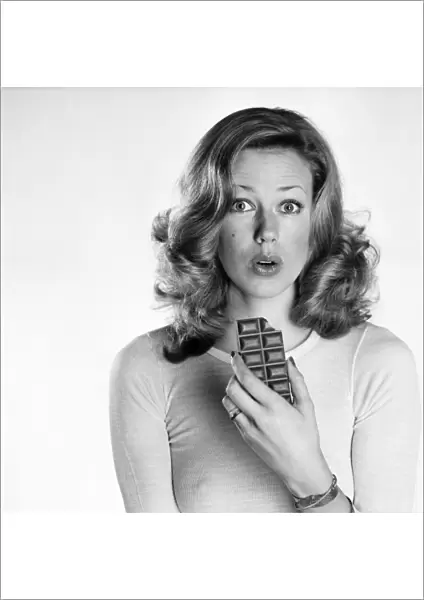 Woman eating chocolate. February 1975 75-00891