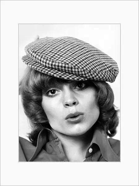 Model Amanda tries a cloth cap. May 1973 P007870