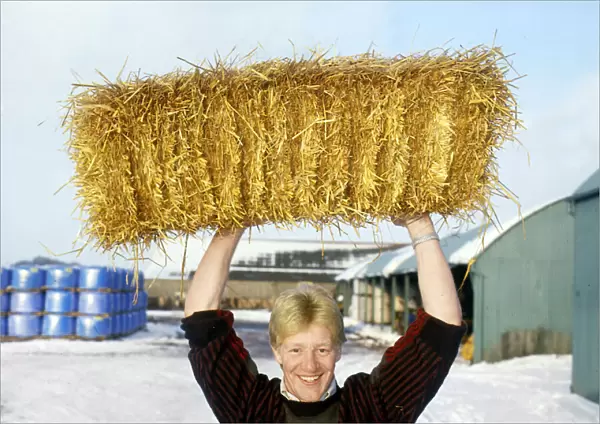 John Jeffrey holding haystack above head February 1986