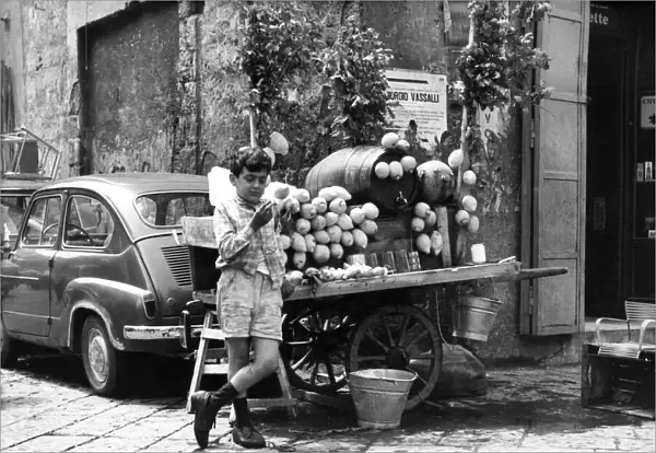 A young boy of Naples in Southern Italy selling goods on the side of the road