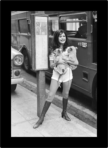 Hammer horror film actress Madeline Smith holds a couple of five week old lion cubs as