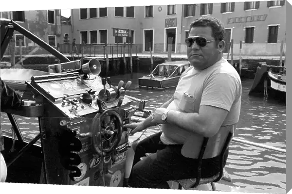 General scenes in Venice. Captain of a water taxi awaits his next fare