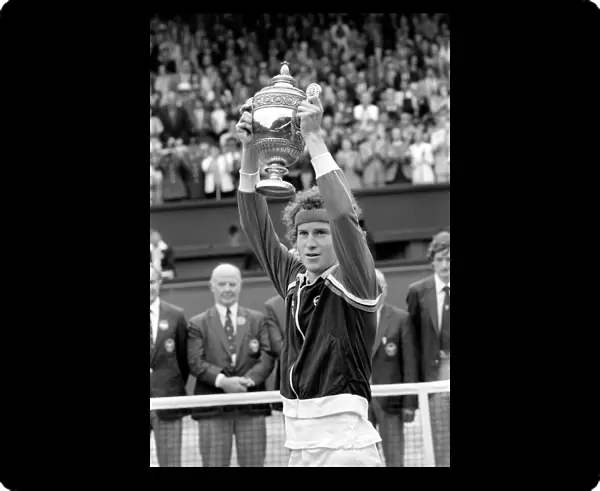 Wimbledon Tennis: Mens Finals 1981: John McEnroe shows of the golden trophy to