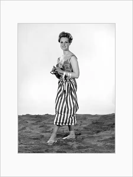 Model Roma Reeves wearing beach toga that doubles as a beach towel. May 1962