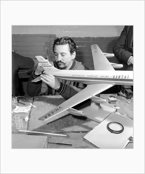 Factory where model aircraft for the travel agents are made. Men making model planes