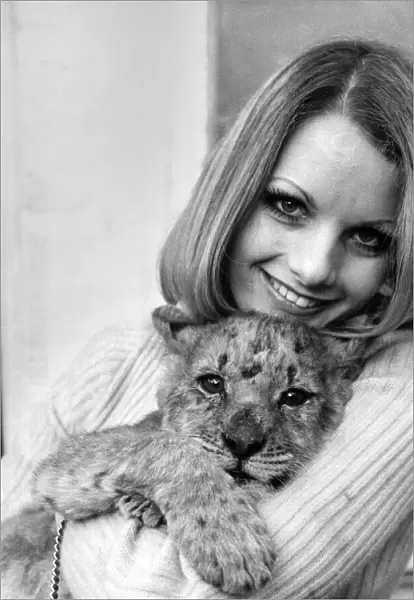 Former model Sally Bunting holding her lion cub pet at her home in Chiswick