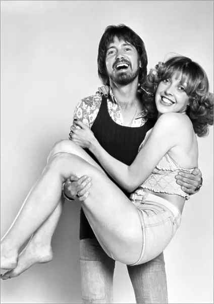 Couple wearing 1970s fashion. The woman wearing a matching top