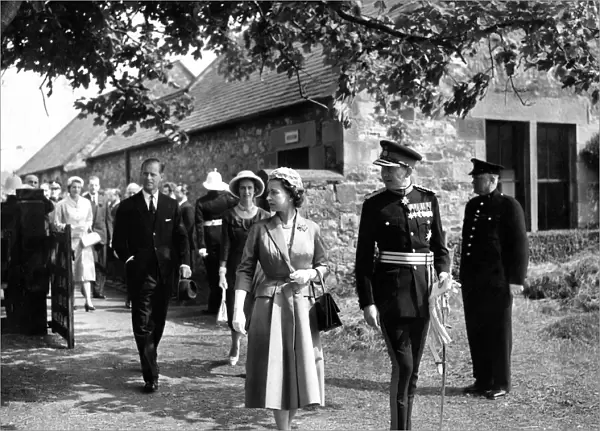 Queen Elizabeth II and the Duke of Northumberland followed by Prince Philip