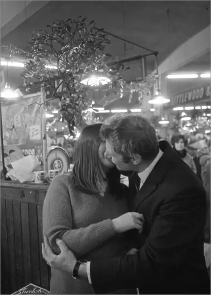 A kiss under the mistletoe for 15-year-old Susan Young from Eric Tweed at Coventry Retail