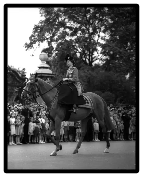 Queen Elizabeth II rides her horse sidesaddle June 1953 towards horseguards parade