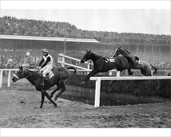 The Grand National 1947 Over the gaping water jump at Aintree