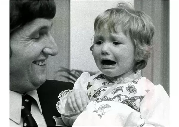 Eighteen month old Clare Timewall held by her father Chris crying her eyes out after