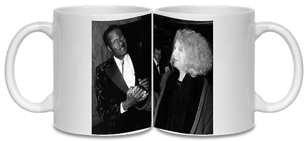 Chuck Berry greets woman at film premiere 1988 Holding hands