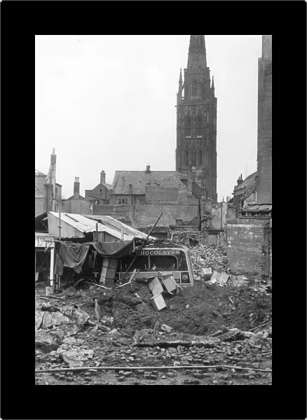 A wrecked van lies in the rubble of ruined buildings in Coventry after the city was