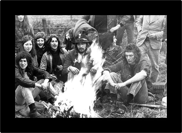Some hippies sitting round a campfire in May 1971