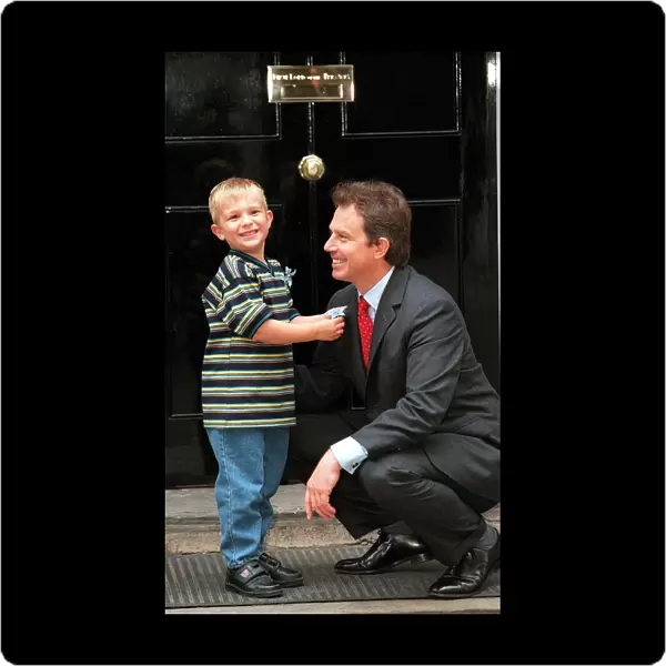 Recovered cancer patient Alexander Taylor (4 ) from Staffordshire presents Prime Minister