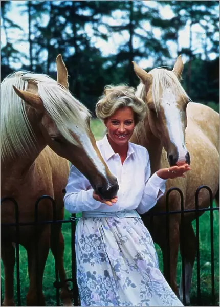 Princess Michael of Kent October 1986 leaning on railings feeding horses