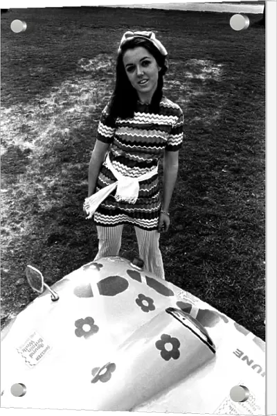 A model in a beach buggy wearing a dress in April 1970