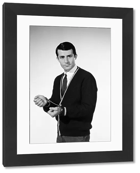 Handcuffs feature. Model Henry Fern in cardigan wearing handcuffs. Circa 1964