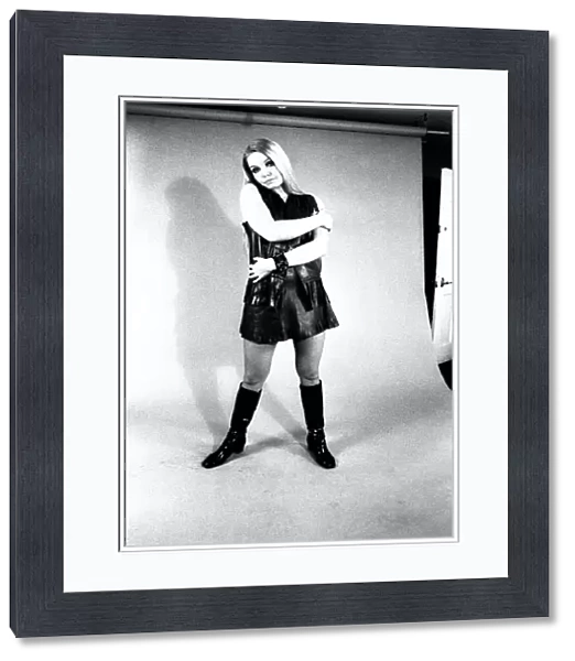 A fashion shoot from 13 April 1970 - A model wears a dress with knee lenght boots